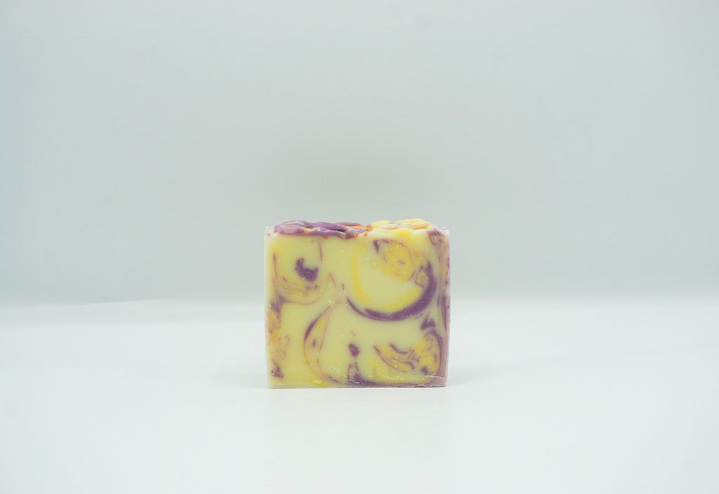 Night Night Kisses bar soap with deep purple and bright yellow swirls.